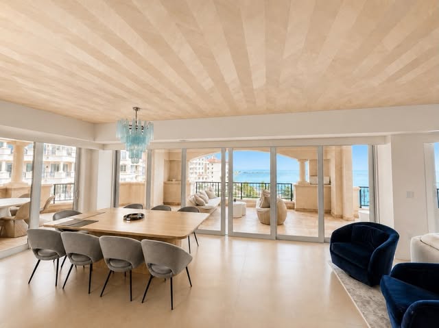Wide living and dining area with detailed custom ceiling treatment