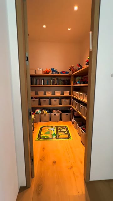 Walk-in storage room with wraparound built-in shelving